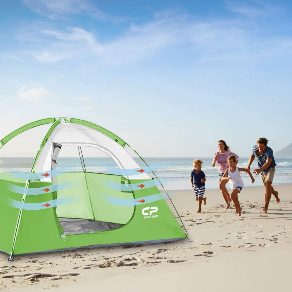 family running toward tent on a beach